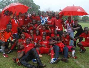 Jubilant Vodafone team displaying the trophy
