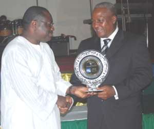 Vice president Mahama presenting top position award to an official of Stanbic.