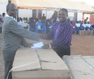 Michael Agbetsomedo left PWD Chairman receiving his donation from Mr. Addinortey, ASHMA MCE