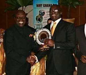Mr Kojo Atta- Krah, Managing Director of PBC, receiving the 1st Prize from Dr Ishmael Yamson.