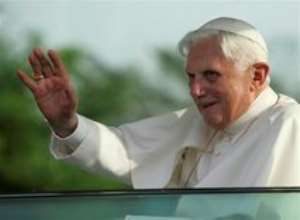 AP – Pope Benedict XVI waves to a cheering crowd as he leaves the airport in Yaounde, Cameroon Tuesday, March 