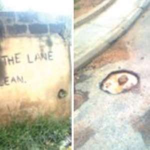 A roadside where garbage is dumped with a warning against the act & Pot holes on one of the streets