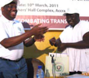 The Director-General of GIABA, Abdullahi Shehu (L), presenting a souvenir to Mr. Martin Amidu, Minister for Justice (r)