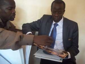 Member of Parliament, Uganda, Alhaj Hussein Kyanjo, reading through Islamic Museum files