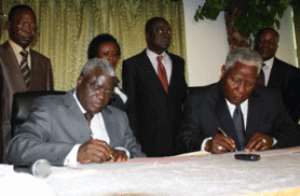 Mr Zakari Nandja, Togolese Minister of Sanitation and Rural Water (Left) and Mr E.T. Mensah, Ghana's Minister of Water Resources, Works and Housing, signing the agreement in Accra,