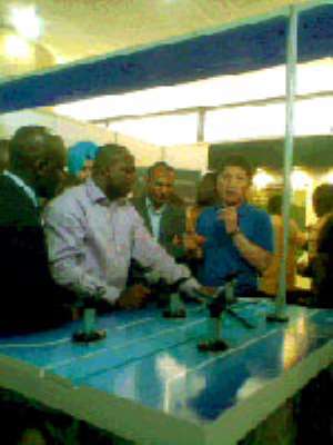 Mr. Bangryong Kim explaining how the Samsung Galaxy Tab works to the Deputy Minister of Communication, Ernest Attuquaye Armah