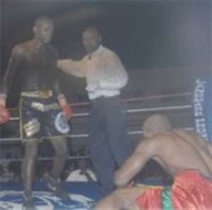 Abbey (left) leaves his opponent Ernest Amuzu sprawling on the canvas after one of his  devastating punches.