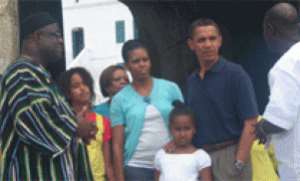 President Obama and family listening to Mr Kwesi Essel Blankson (right), the official tour guide of the Cape Coast Castle