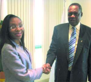 Mrs. Sarafa-Yusuf Omodele in a handshake with Alhaji Issa Hayatou after the contract