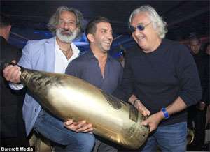 Splashing out: Brett Berish, CEO of Armand de Brignac Champagne, Charles Shaker and Flavio Briatore hold up a 30-litre Midas bottle of Armand de Brignac champagne at the Billionaire Club in Monte Carlo