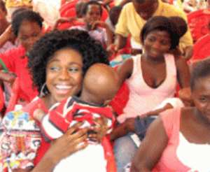 Afro-pop Becca with one of the children she has registered