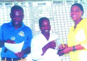 : Mrs. Carol  Boakye, grand daughter of PD Quartey receives her 9-Hole prize from Betty Brown.With them is Obeng Appiah, treasurer of Achimota golf  Club