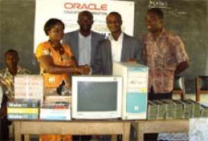 Technology Pre-sales Consultant of OEF, Mr Harry K. Tetteh second right, presenting the items to the Headmistress of the School, Mrs Margaret Antwi left.