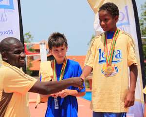 Promasidor8217;s Inusah Musah L congratulating Tazana Kamanga Dybak of Lincoln Community School for winning the boys 100m breaststroke