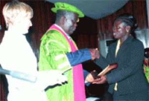 Prof. K.K. Adarkwah, (middle) Vice Chancellor of KNUST, presenting the Canada Optical Laboratory Award to Dr Afua Asantewaa of (KNUST)
