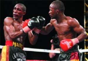 Joseph Agbeko penetrates the guard of Yonnhy Perez left on his way to reclaiming his title.