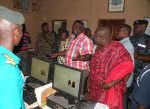 Volta Regional Minister Afotey Agbo interacting with immigration officials
