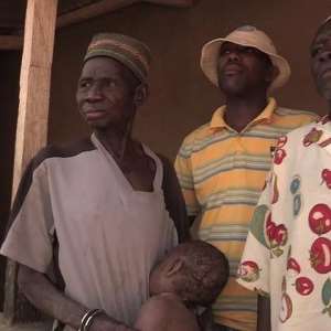 The two accused persons with the prosthetic baby and a police officer