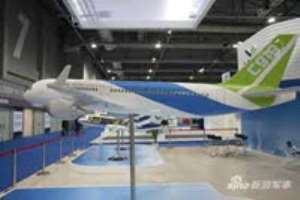 Visitors inspect the C919 prototype at an aviation exhibition during the Zhuhai Airshow
