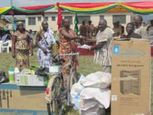A Member of the Council of State, Mr. Paul Adjei Annan 3rd right presenting an award to the Overall Best Farmer in the Tema Metropolis for 2010, Nii Narh Abotsi