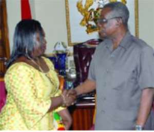 President Mills congratulating Mrs Beatrice Rosa Brobbey after she had been sworn in as Ghana's Ambassador to Guinea