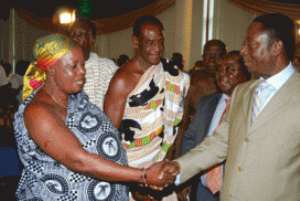 Dr Kwabena Duffuor congratulating Nana Akyea Nantie, Queen Mother for Cocoa, Coffee, Sheanut Farmers Association