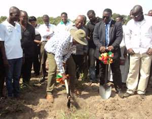 Mr. Ofosu-Ampofo breaking the ground for work to begin on the mortuary while the regional minister and Tema Mayor look on