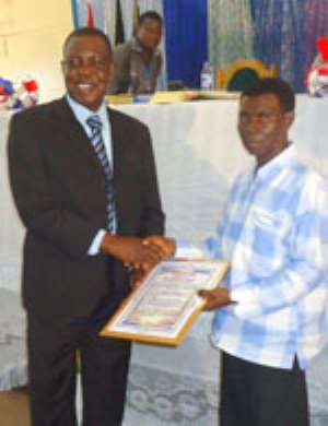 A Pastor of the EP Church presenting a citation to Mr. George Achibrah left on behalf of the Moderator of the General Assembly at the 3rd General Assembly in Ho