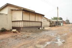 Waste water from houses flows on to the road because there are no drains/gutters