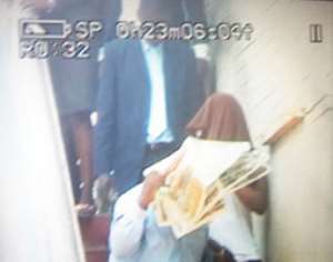 Two of the convicts covering their faces