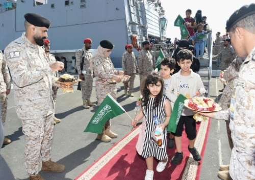 Members of the armed forces pass out chocolates and flowers to Saudi citizens and other nationals upon their arrival in Jeddah, following their rescue from Sudan. By - SPAAFP