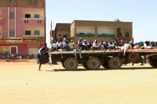 Sudanese crowd onto a truck to flee fighting in Khartoum. By - AFP