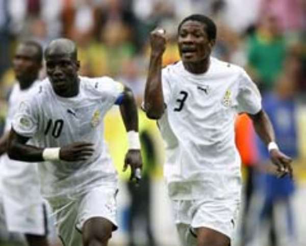 AngoGhana's Asamoah Gyan (centre) and Stephen Appiah complain to the linesman who did not signal for off side for Brazil's second goal.