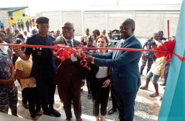 The Commissioner of the Customs Division of the GRA, Colonel Kwadwo Damoah (retd) (left), Mrs Briget La Cour Madsen (2nd right), and Mr Isaac Crentsil of the Ministry of Finance (2nd left), cutting the tape to inaugurate the dog training complex.