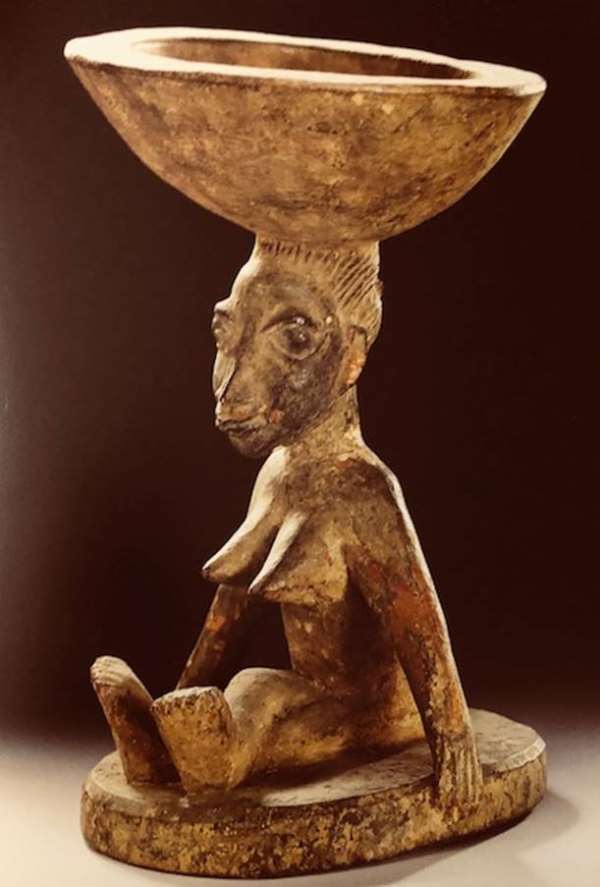 Ifa bowl, agere ifa, carried by a seated woman, Yoruba, Nigeria, now in Ethnologisches Museum, Berlin, Germany.<