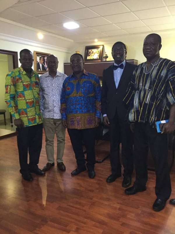Secretary General of IACO, Dr. Frederick Kawuma (In suit) in a pose with the Minister (middle)