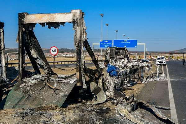 Protesters set fire to trucks on the main road between the port in the city of Durban, KwaZulu-Natal, and the industrial heart of South Africa.  - Source: Photo by Darren Stewart / Gallo Images via Getty Images