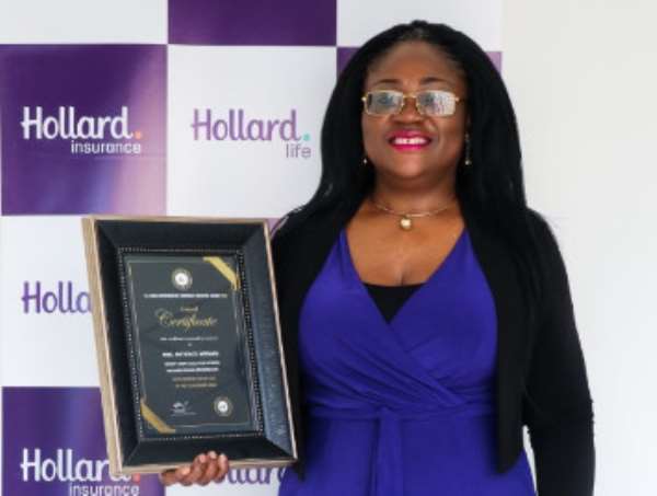 The Group Chief Executive Officer (CEO) of Hollard Ghana, Patience Akyianu showcasing her award