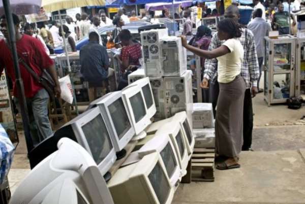 A used-computer vendor attends to a buyer at Lagos' computer village in 2006. By Pius Utomi Ekpei (AFP/File)