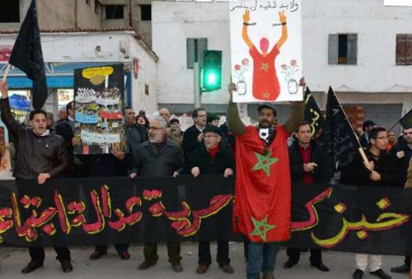 Moroccans hold placards and shout slogans as they take part in a demonstration in Rabat, organised by the pro-reform February 20 movement on February 17, 2014. By Fadel Senna (AFP/File)
