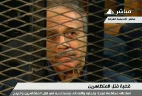 An image taken from Egyptian state TV shows former Egyptian interior minister Habib al-Adly sitting behind bars during a hearing in his retrial at the Police Academy in Cairo on July 6, 2013. By (Egyptian TV/AFP)
