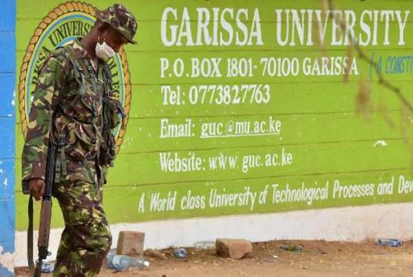 A Kenyan soldier walks past the entrance of Moi University in Garissa on April 3, 2015, a day after the massacre of 148 people by Somalia's Shebab fighters. By Carl de Souza (AFP/File)
