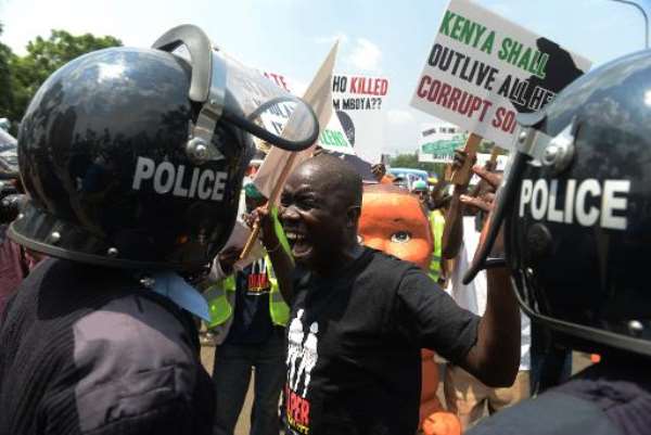 A man shouts at riot police during a demonstration held to highlight rising cases of corruption in government, insecurity, unemployment and poverty in Nairobi on February 13, 2014. By Simon Maina (AFP/File)
