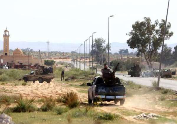 Fighters from Fajr Libya (Libya Dawn), an alliance of Islamist-backed militias, take positions during clashes with an opposing militia in Bir al-Ghanam, around 50 kilometres (30 miles) from the capital, on March 19, 2015. By Mahmud Turkia (AFP/File)