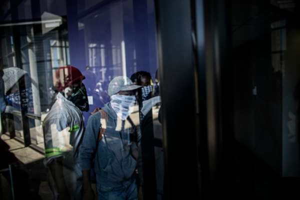 Masked students enter a building at Witwatersrand University in Johannesburg on October 10, 2016. By Marco Longari (AFP)