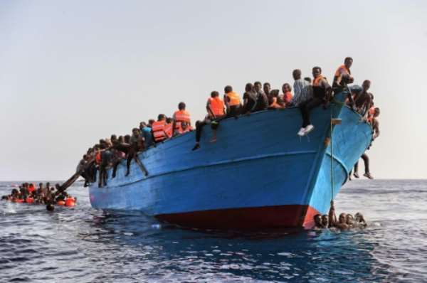 Migrants wait to be rescued in the Mediterranean Sea off the coast of Libya on October 4, 2016. By Aris Messinis (AFP)