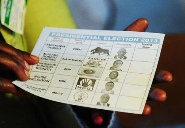 A Zimbabwean voter holds a ballot paper at a polling station in Domboshava, on July 31, 2013. By Alexander Joe (AFP/File)