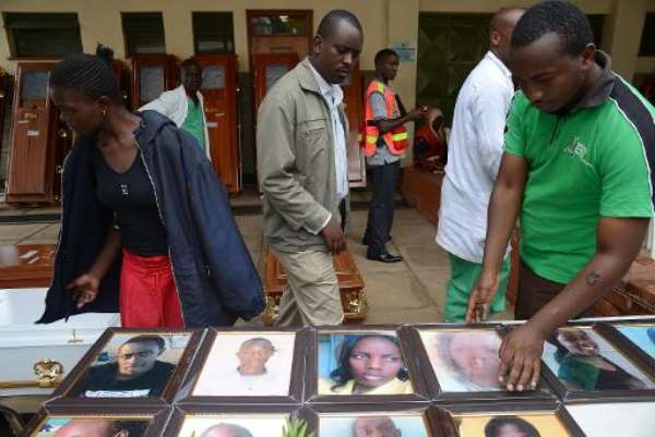 Relatives look at portraits of students killed in last week's attack on the Garissa University campus by Somalia's al-Qaeda-linked Shebab insurgents, at the Chiromo morgue, on April 9, 2015 in Nairobi. By Simon Maina (AFP)