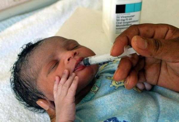 A newborn baby girl, daughter of a HIV-positive mother, receives an anti-retroviral drug. By Anna Zieminski (AFP/File)