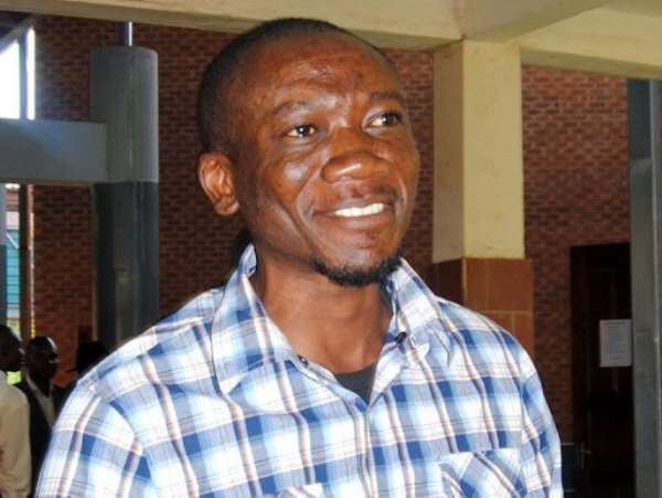 Prominent Zambian gay rights activist Paul Kasonkomona (C) leaves the Lusaka magistrate court on April 11, 2013. By Joseph Mwenda (AFP/File)
